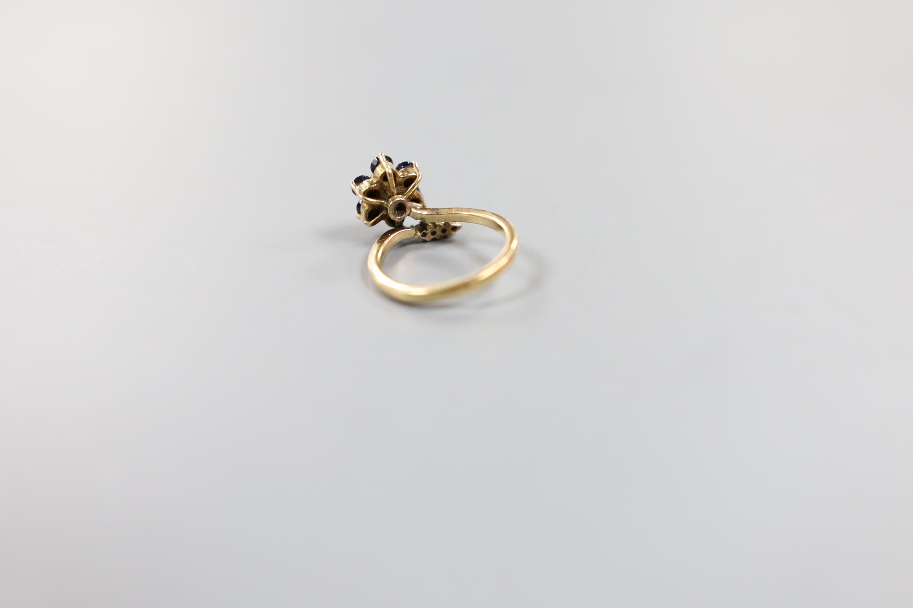 A 585 yellow metal, sapphire and diamond set dress ring, size G, gross weight 2.9 grams.
